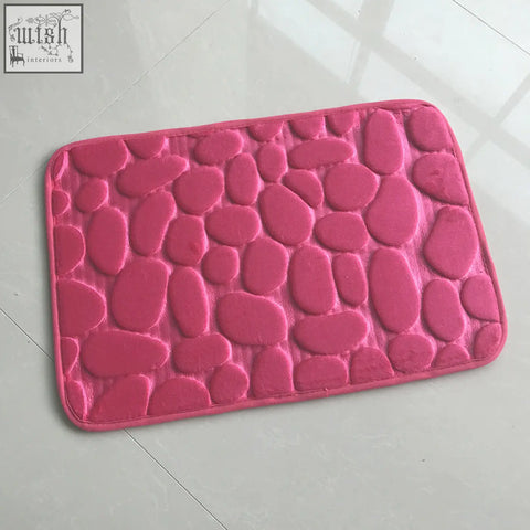 Pink pebble textured floor mat made of memory foam for water absorption perfect as bathroom or door carpet