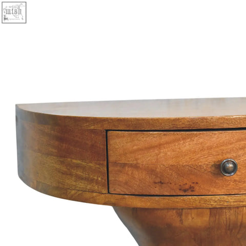 Warm-toned wooden pedestal curved bedside with a curved top and single drawer with round metallic knob