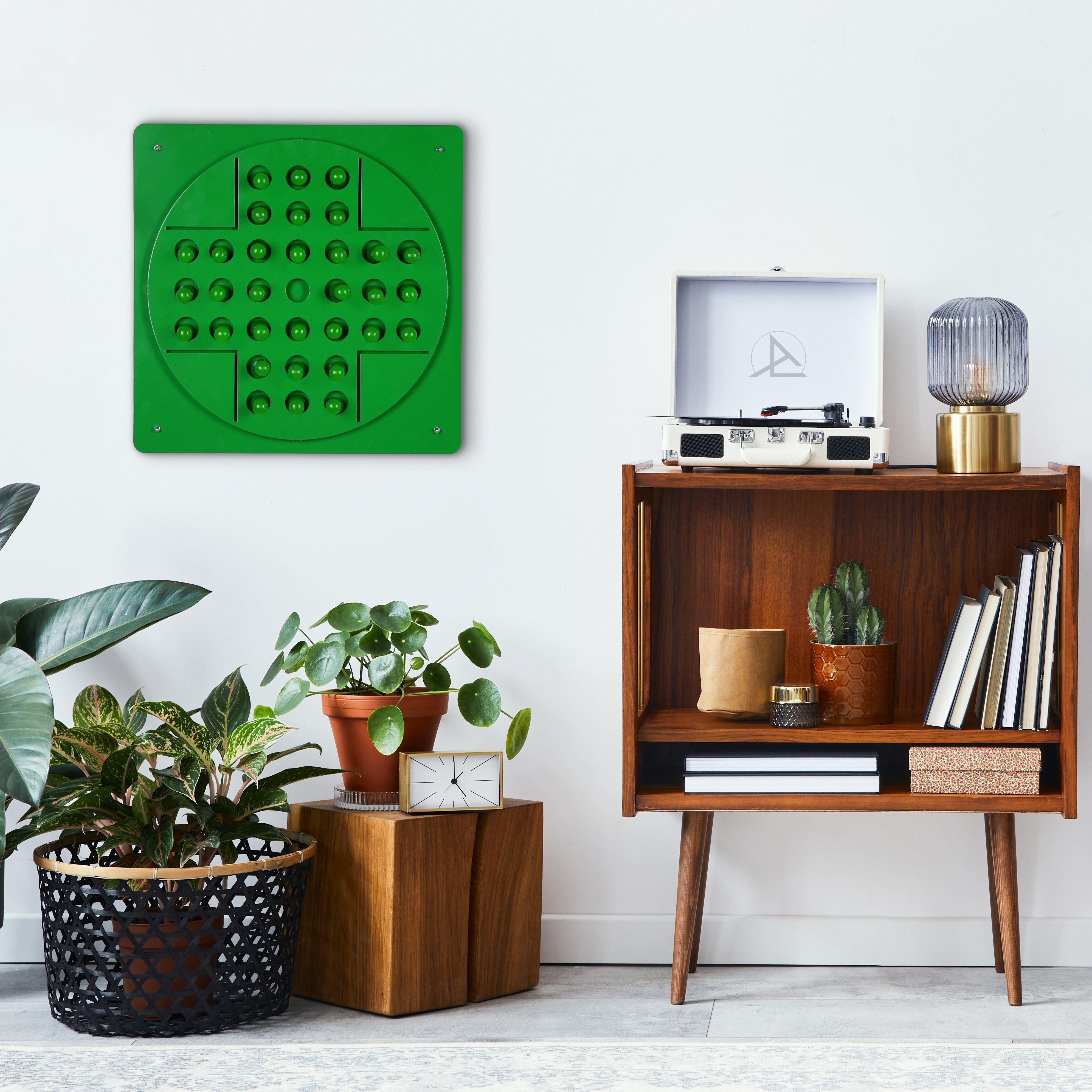 Green peg solitaire wall art with vibrant hues featuring a circular pattern of raised spheres and color options