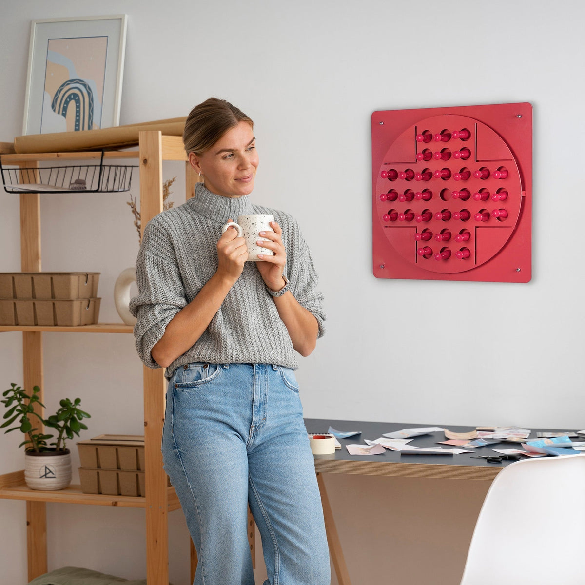 Red circular peg solitaire pink sensory board with translucent spheres arranged for solo test and hanging instructions