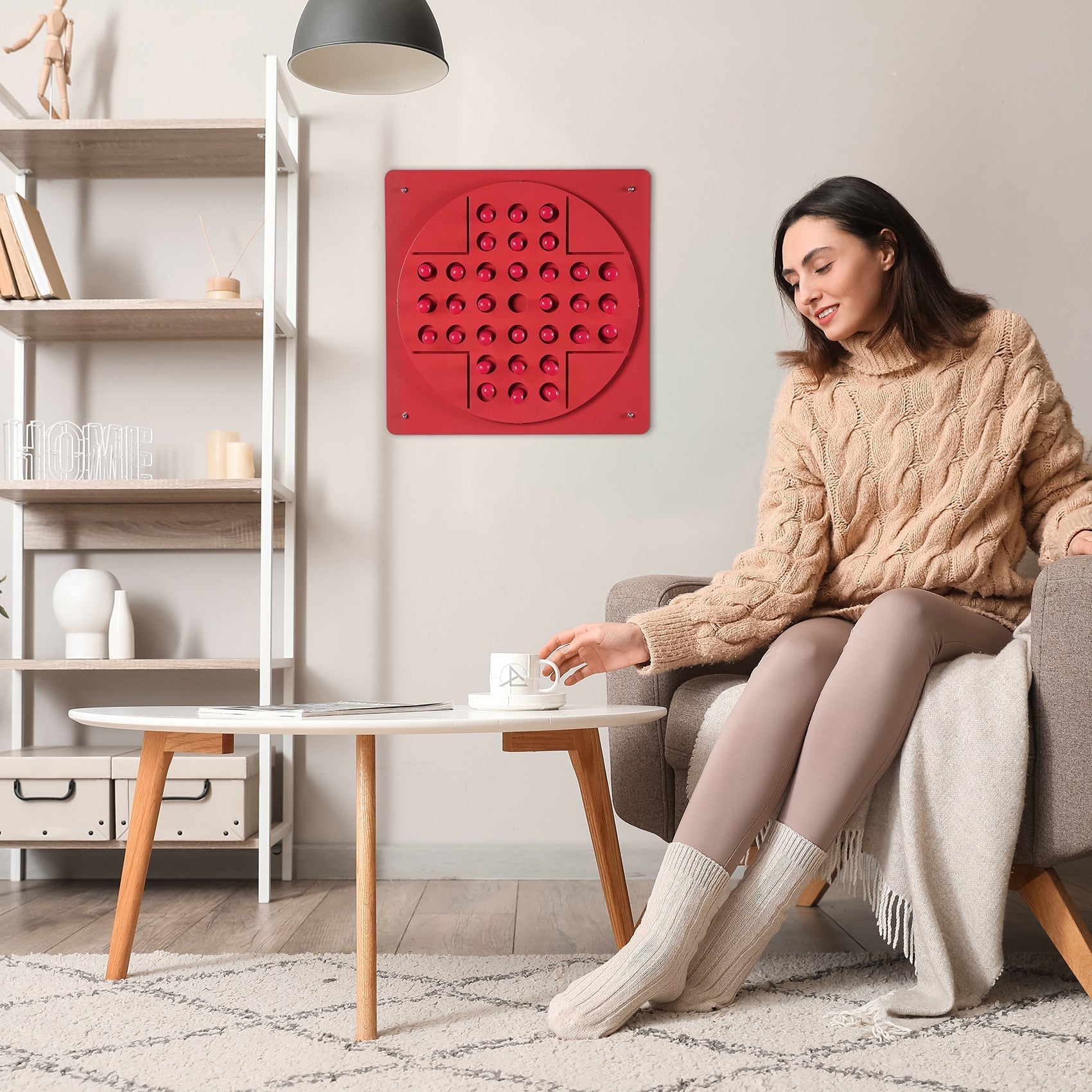 Pink peg solitaire solo test panel with red circular tactile dots and hanging instructions for age range use