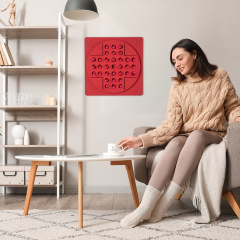 Pink peg solitaire solo test panel with red circular tactile dots and hanging instructions for age range use