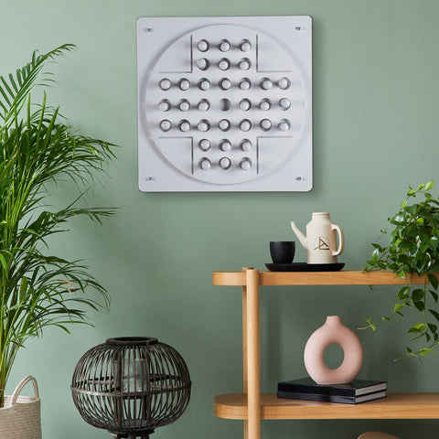 White circular peg solitaire wall art with raised knobs in concentric circles perfect for solo test and hanging instructions