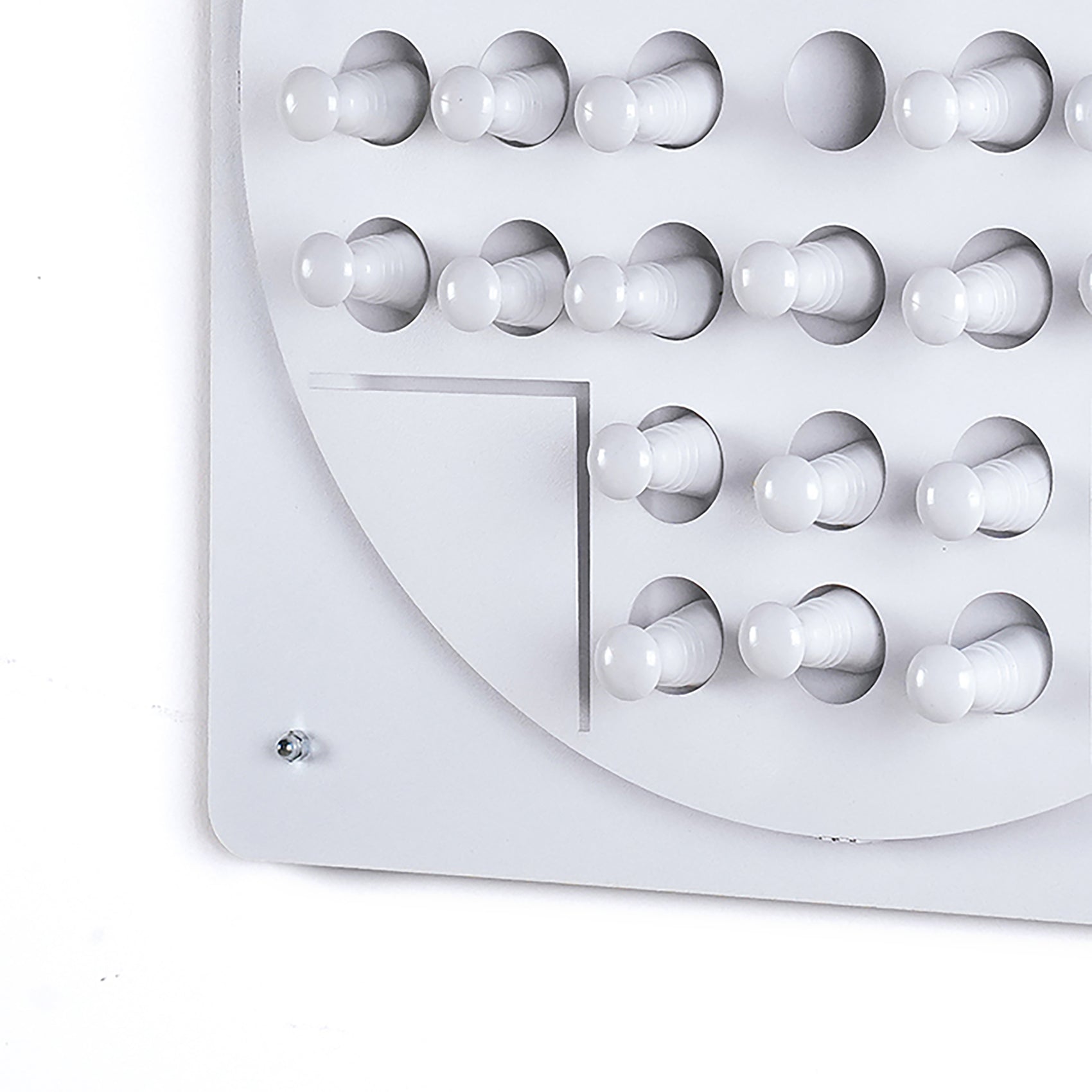 White plastic wall-mounted coat rack with rounded pegs suitable for organizing jackets during solo test or peg solitaire age range activities