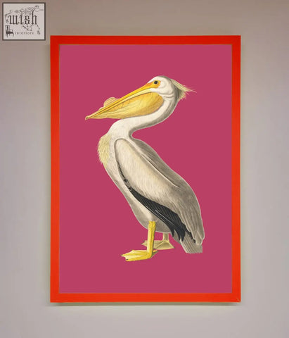 A pink framed poster of a detailed white pelican with yellow beak and feet on a vibrant pink background with orange border