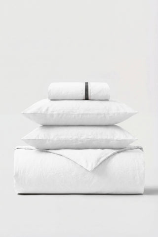 White cotton percale essentials bedding set with subtle black woven band on rolled pillowcase