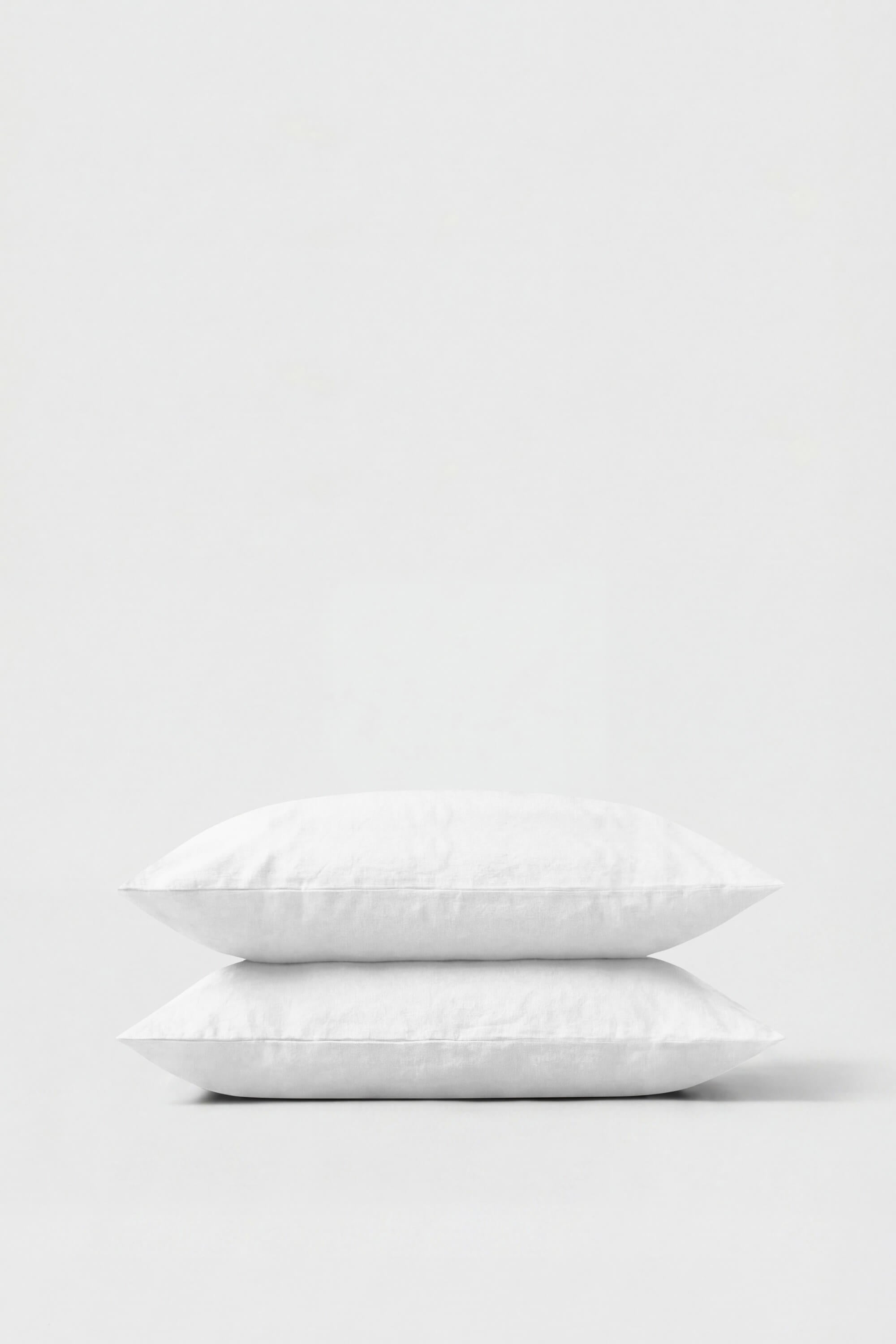 White cotton percale pillowcase pair neatly stacked showing smooth breathable fabric perfect for restful sleep