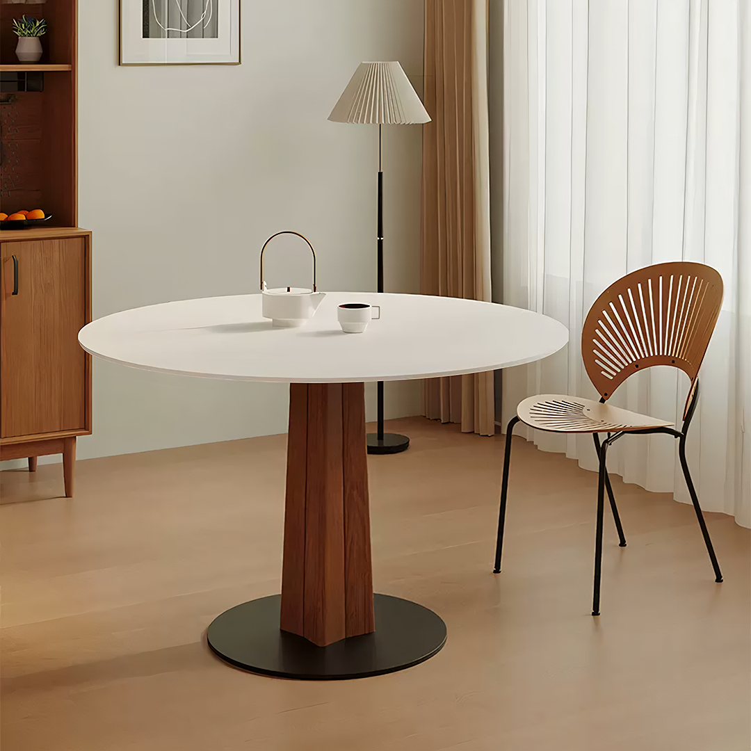Percival white round dining table with wooden pedestal base and black circular foot perfect for white round dining rooms