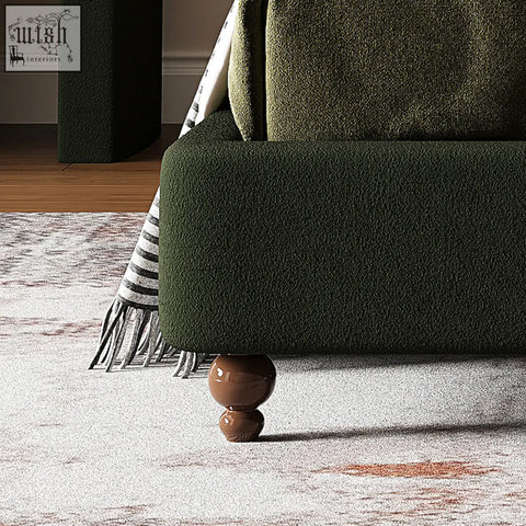 Dark green velvet sofa leg with glossy brown spherical finials on a persephone shell double king size bed