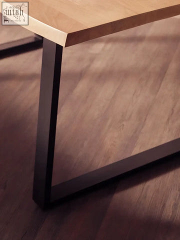 A sleek mango wood live edge dining table with light wood top and black metal legs for modern dining spaces