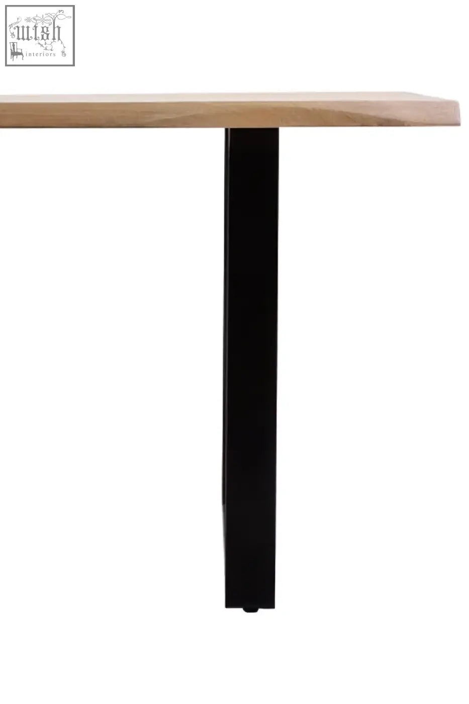 A sleek black metal leg supports a light mango wood live edge tabletop on the persolo dining table