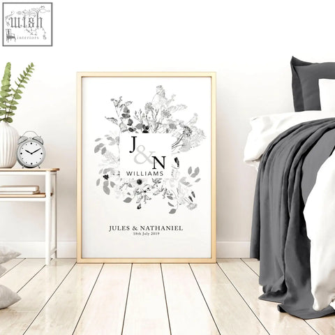 A framed black and white personalised wedding anniversary wall art print with floral monogram and initials j and n