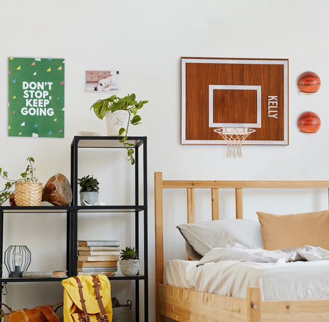 Personalization wooden single hoop walnut with white rim and net mounted on wall above bed