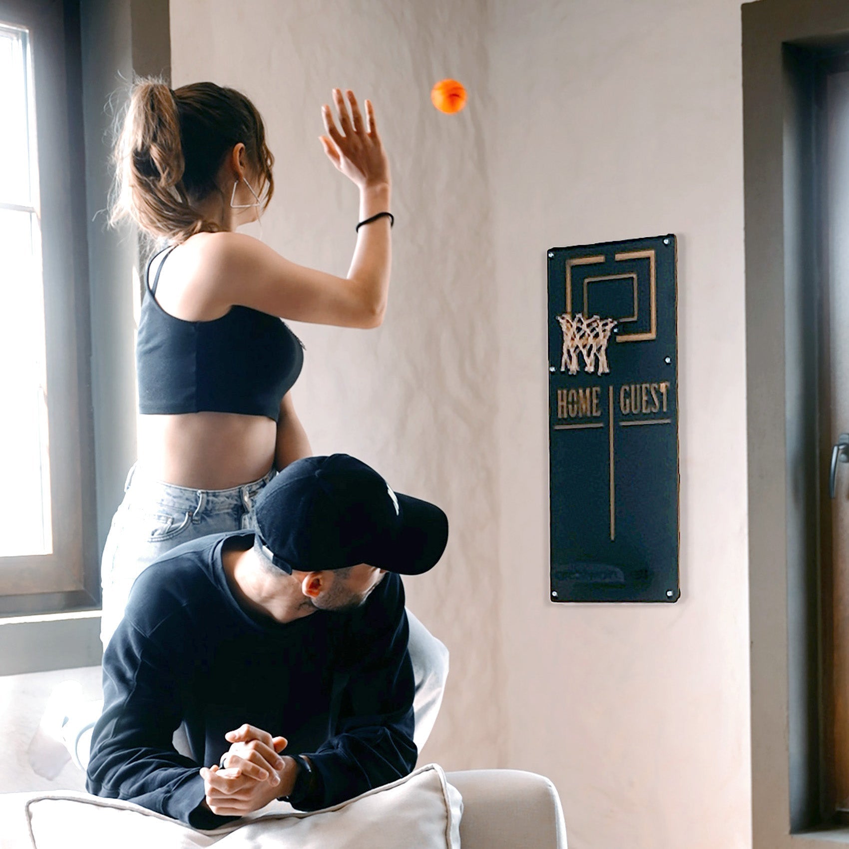 Personalized orange basketball wall decoration with home guest text and gold trim perfect for a basketball wall game