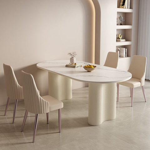 Cream-colored marble peru dining table with oval top and ribbed cylindrical legs perfect for dining table use