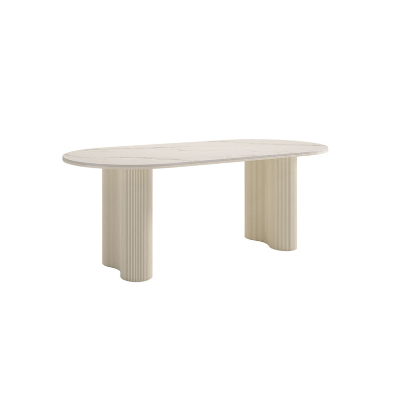 Cream-colored peru dining table with smooth light stone top and fluted tapered legs for elegant dining