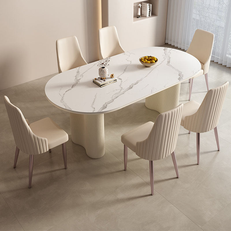White marble-effect oval peru dining table with cream ribbed pedestal legs perfect for stylish dining areas