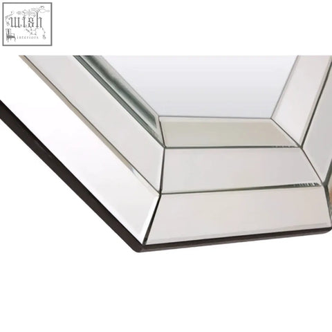 A sleek petillo octagonal wall mirror with multiple beveled glass panels framed in black for modern decor