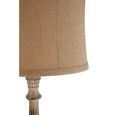 Beige burlap lampshade with a distressed ornate metal base on the petra table lamp for stylish lighting