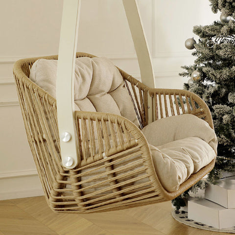 Beige cushioned phedra rattan garden hanging egg chair with white leather straps for indoor outdoor use