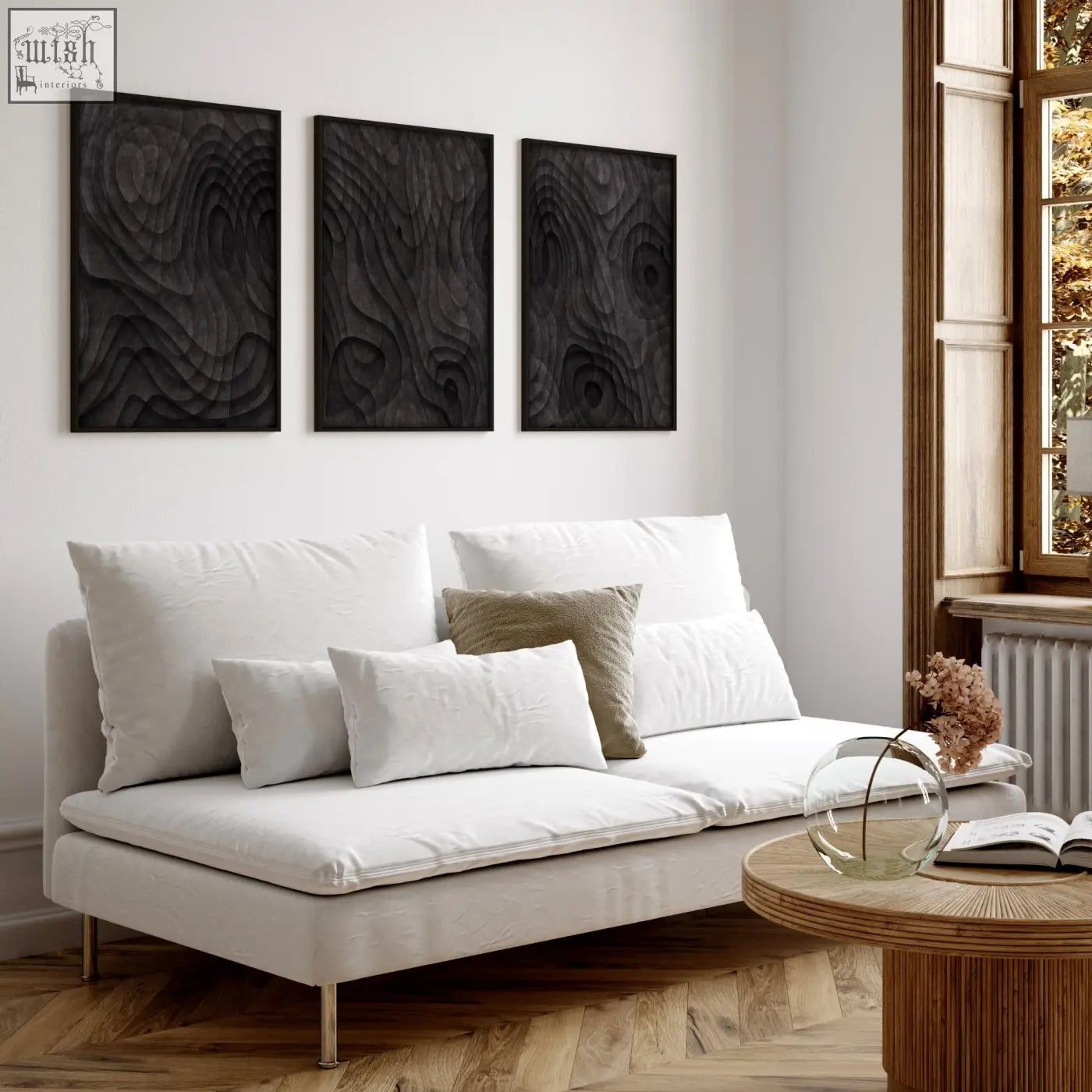 White upholstered sofa with sleek metal legs and cushions in living room with dark brown abstract wall art prints set of 3