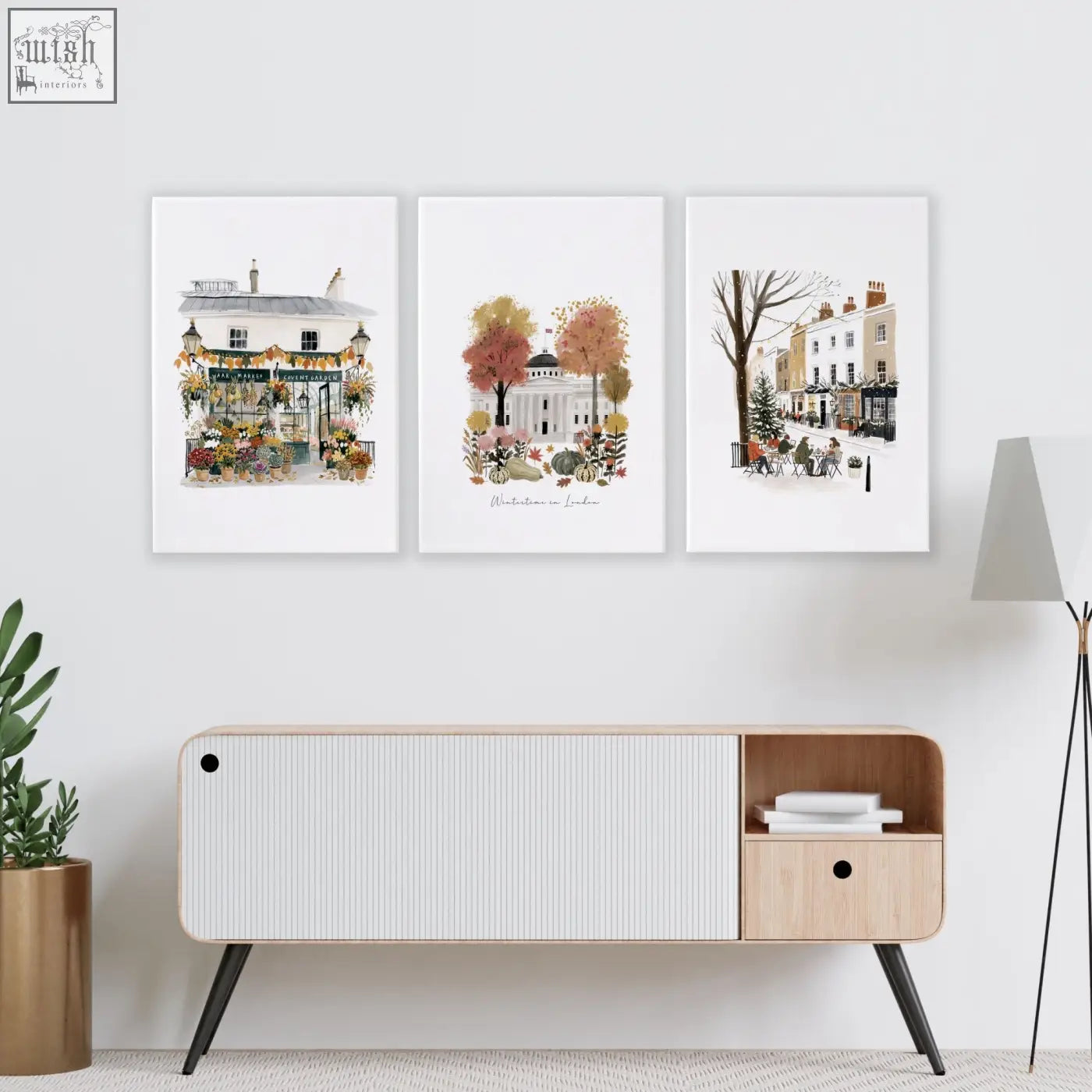 Three framed watercolor london travel wall living room prints above a modern wooden console table with black legs