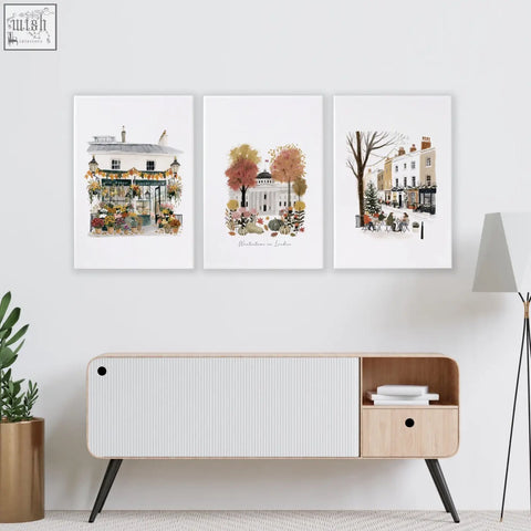 Three framed watercolor london travel wall living room prints above a modern wooden console table with black legs