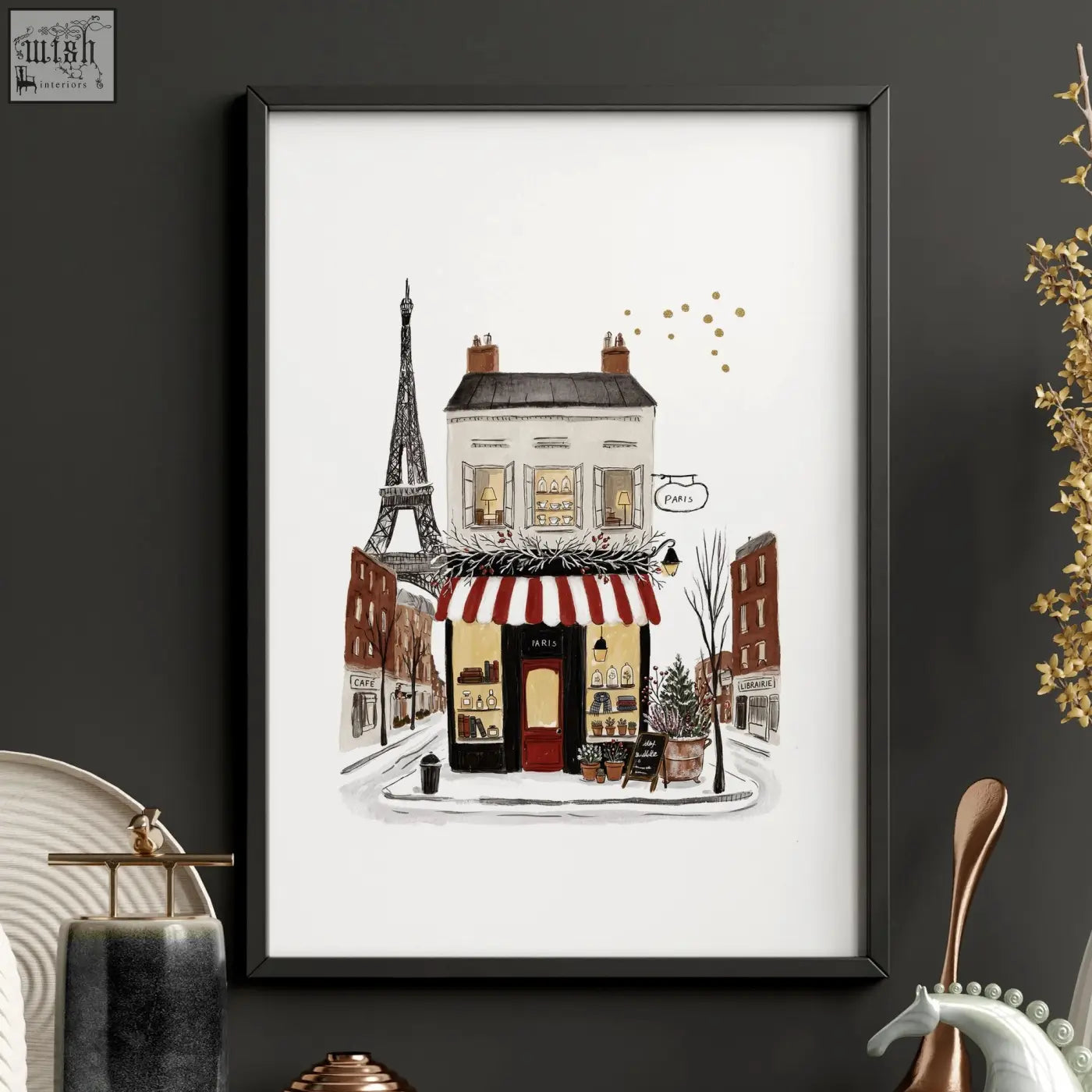 A framed illustration of a paris boutique street with a red and white awning eiffel tower and gold dots pour toujours