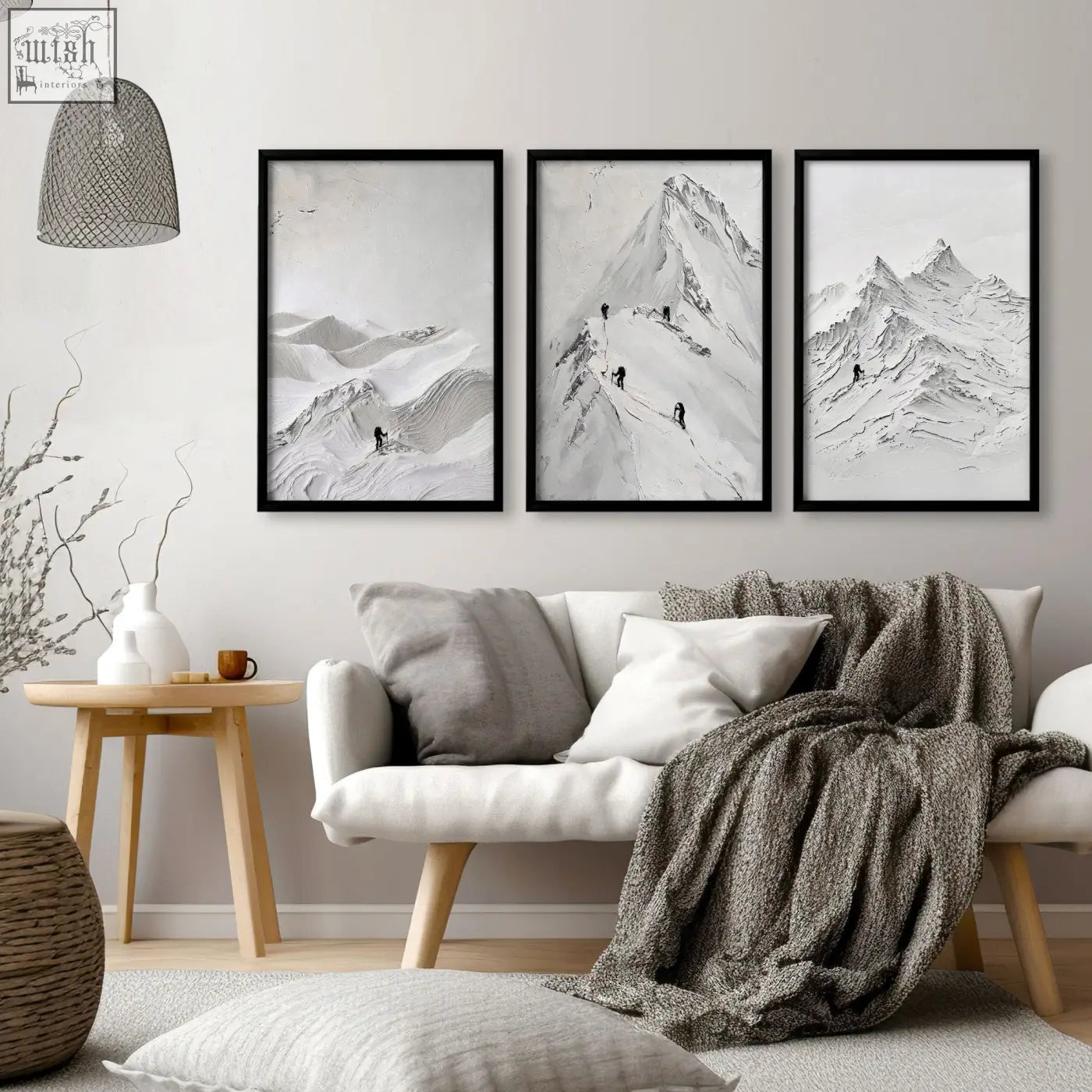 Three black-framed monochrome mountain prints for living room walls above a white sofa perfect for room walls decor