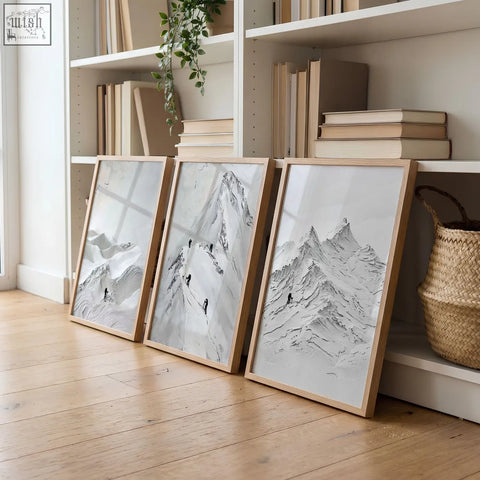 Three framed black-and-white scandi mountain climbers wall art prints with wooden frames for living room walls