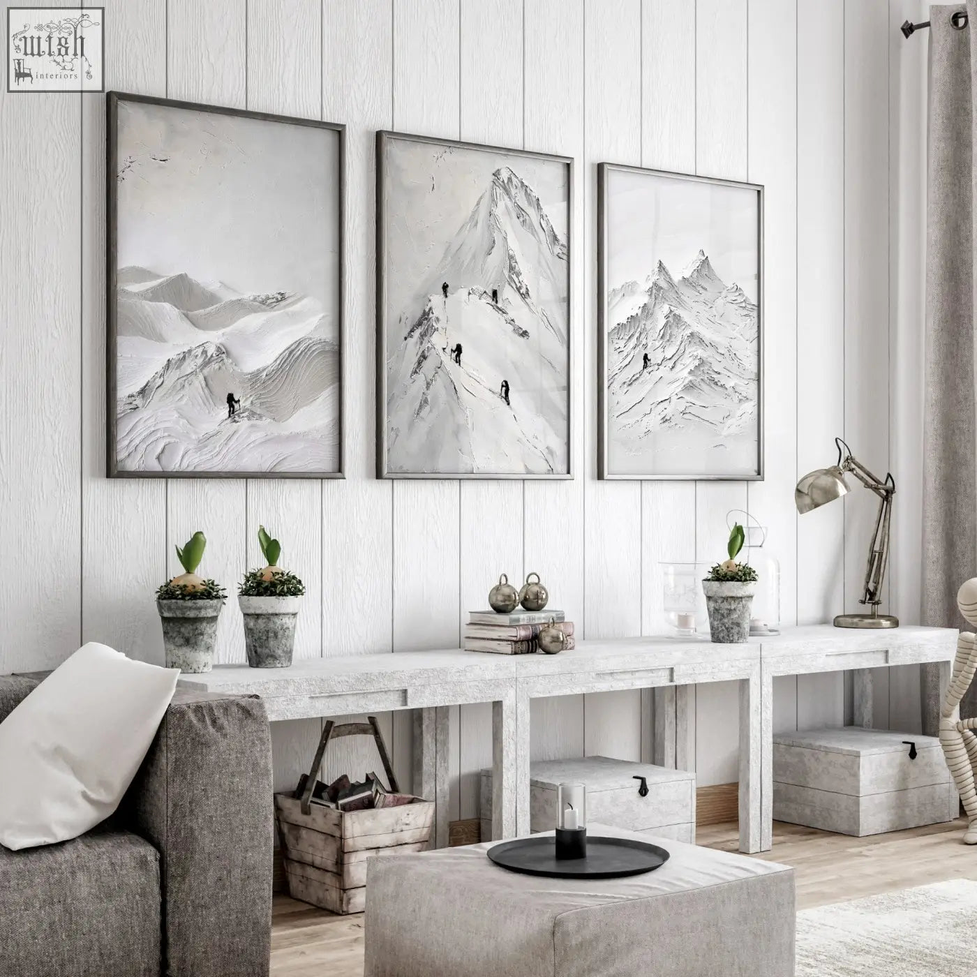 Three black and white framed mountain landscape prints hanging on white wooden wall for living room walls decor