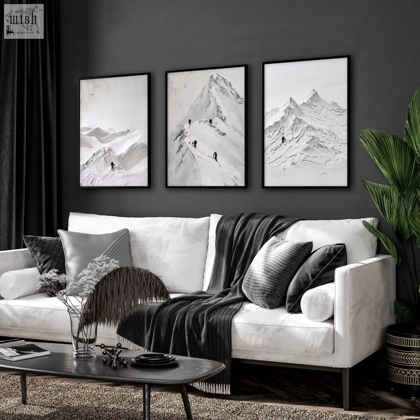 Three framed black and white scandi mountain climbers prints mounted on dark wall for living room walls decor