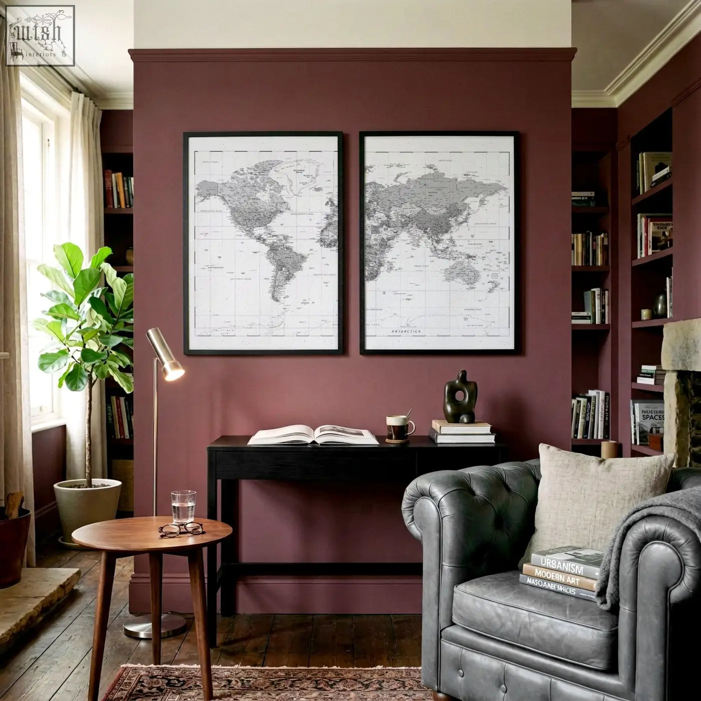 Dark gray tufted leather armchair with beige cushion and stacked books in living room with vintage grey world map wall art