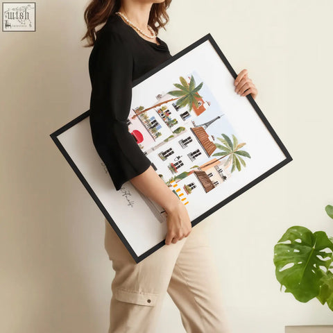 Black-framed illustrated wall art prints featuring sotto il sole european architecture and palm trees on white paper