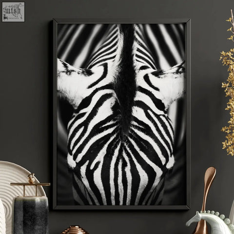 Black-framed black and white wildlife art print of two zebras facing each other for living room wall decor