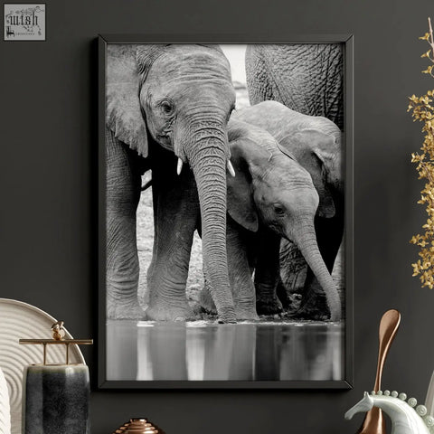 Black framed black and white wildlife safari art print of elephants at a waterhole for living room wall decor