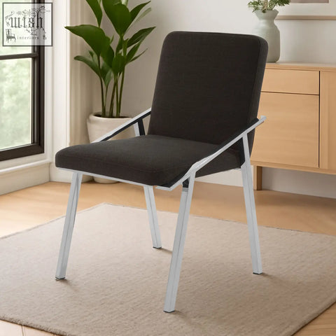Modern black dining chair with sleek white metal frame and black upholstered seat perfect for dining areas