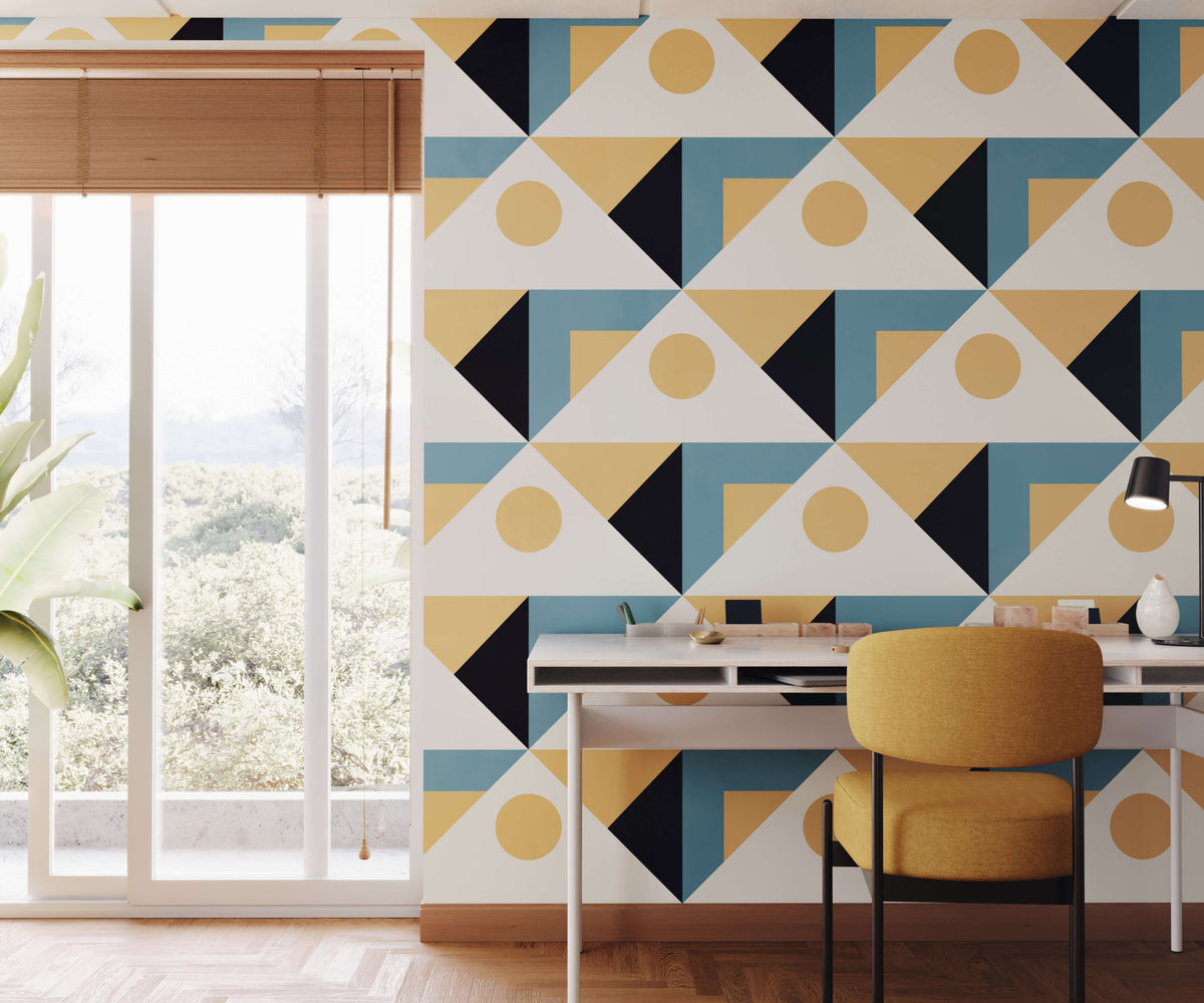 Yellow upholstered pierre chair with black metal legs against geometric triangle wallpaper background