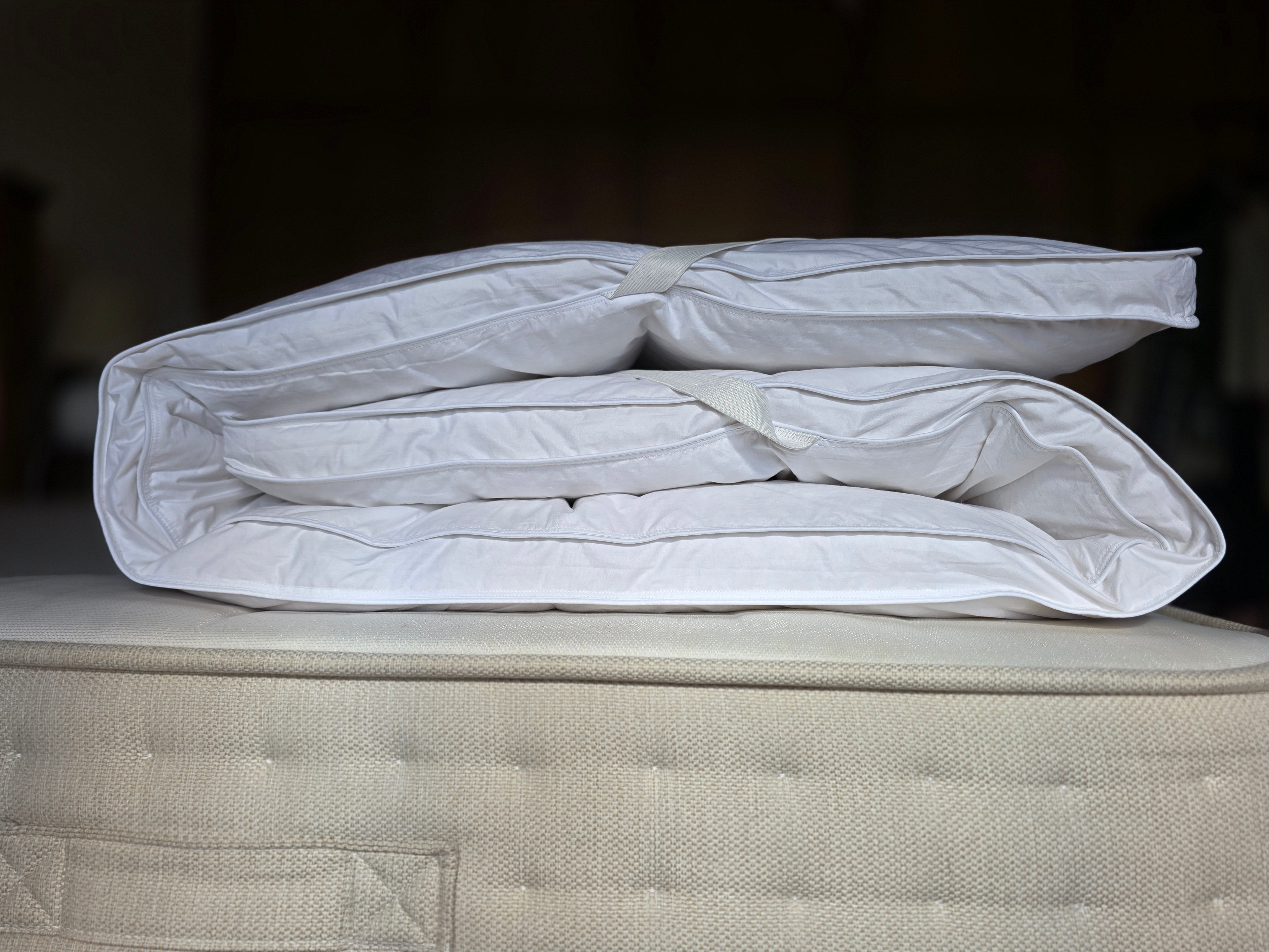 White quilted pillowpillow luxury mattress topper with duck feather filling and plush texture for sleep solutions