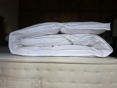 White quilted pillowpillow luxury mattress topper with duck feather filling and plush texture for sleep solutions