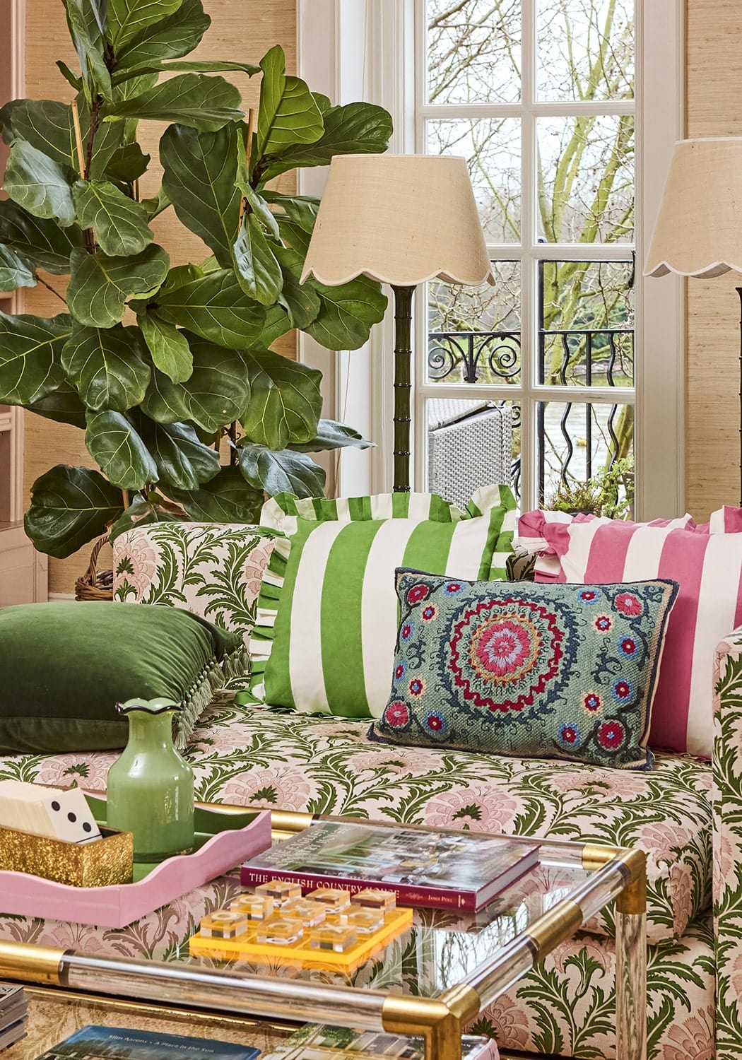 Patterned green and pink floral sofa with pink candy cabana stripe ruffled cushion cover and striped pillows