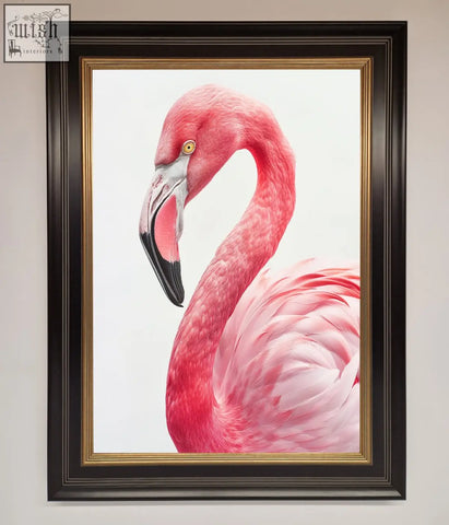 A vibrant pink flamingo stare framed print in a sleek black frame with gold inner trim perfect for wall decor