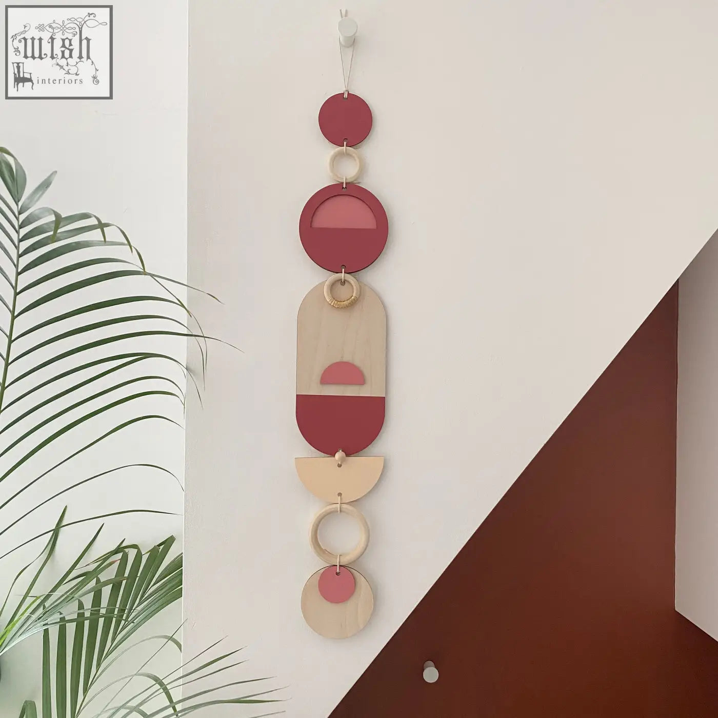 Pink modern wall art featuring layered wooden geometric shapes in muted reds beige and pink tones for modern wall decor