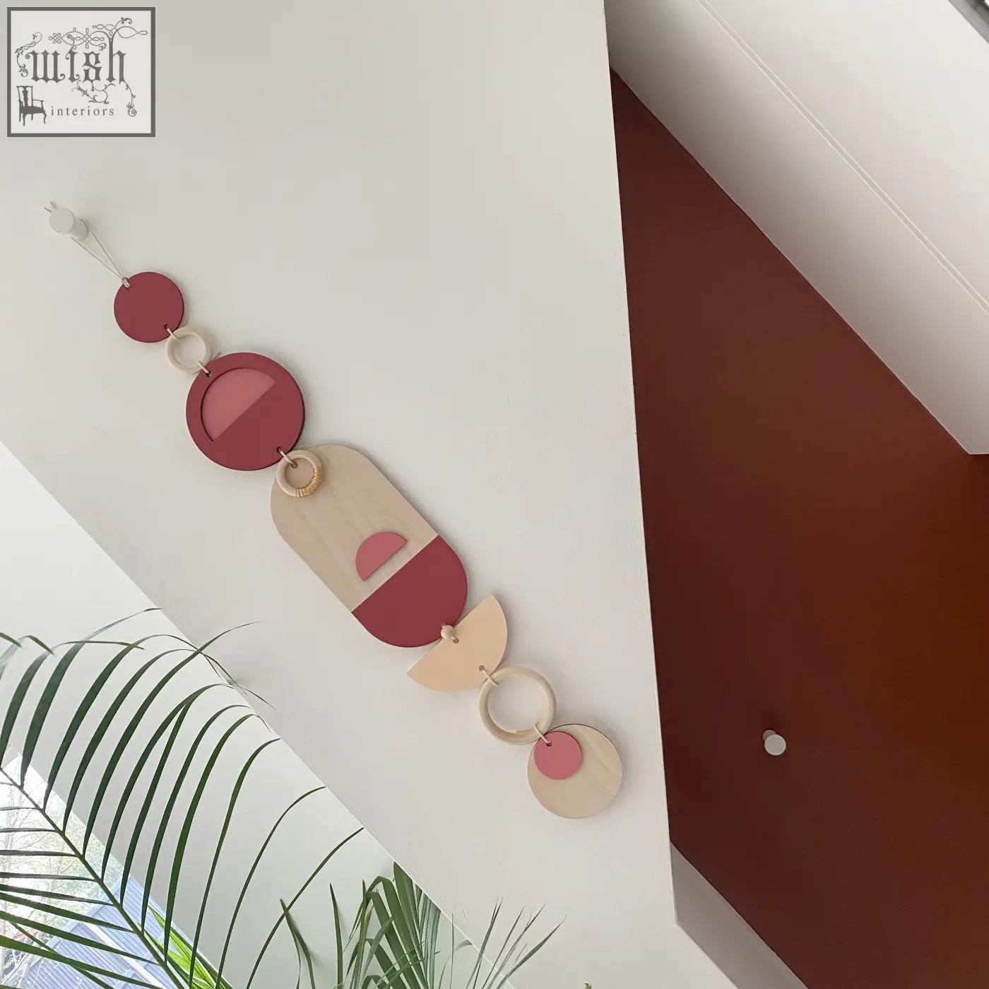 A modern wall art geometric wood hanging with terracotta beige and cream shapes perfect for minimalist decor