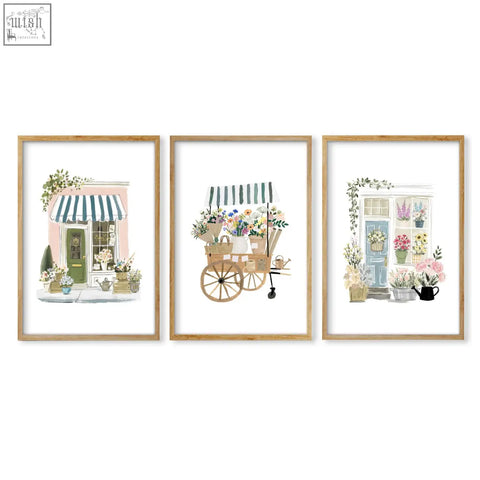 Set of three pink picture flower shop art prints in light wood frames perfect for botanical wall decor