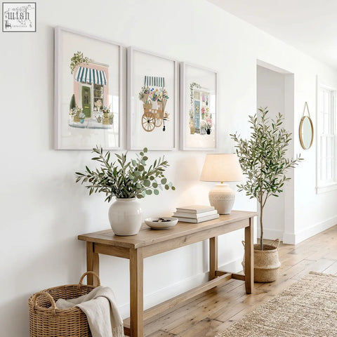 Light beige ceramic table lamp with soft linen shade shown alongside pink picture flower shop wall art prints set of 3