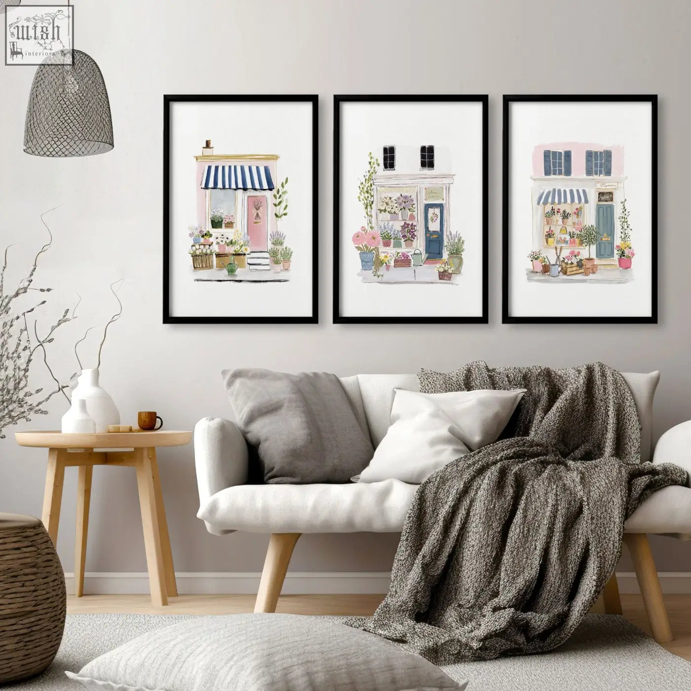 Three framed watercolor country cottage wall art prints with pastel storefronts perfect for living room decor