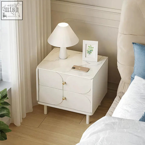 Placebo bedside table with white marble top, two drawers, gold-tone handles, and slender legs in sintered stone style