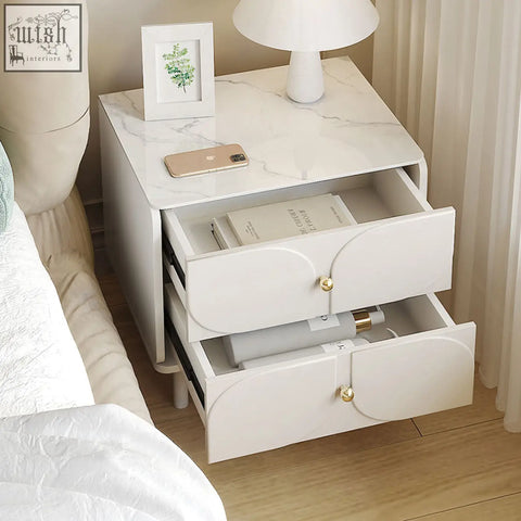 White marble-top placebo bedside table with two drawers and gold-toned handles in sleek modern design
