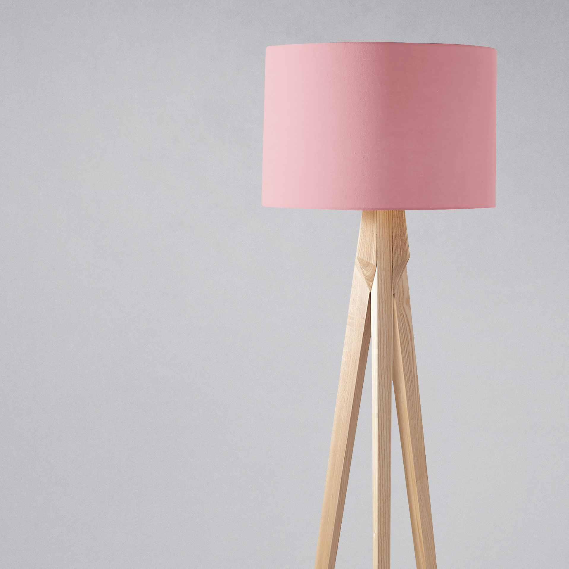 Minimalist tripod floor lamp with dusty rose lampshade and light wooden legs perfect as a plain dusty rose table lamp